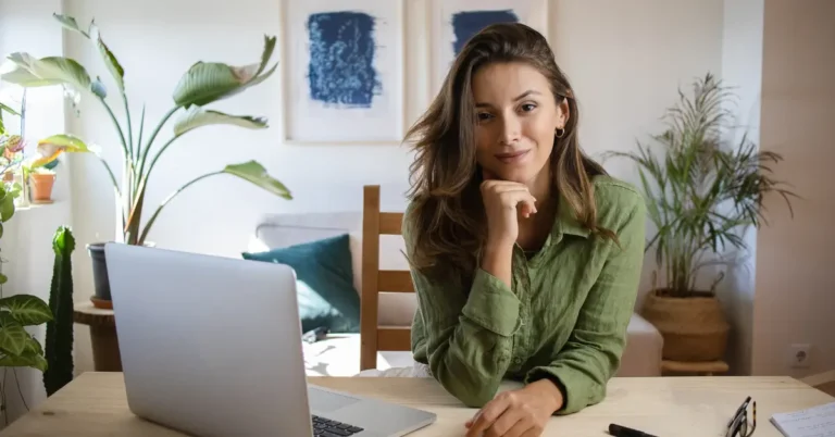 A person working from home on a laptop, representing side hustles for career changers.