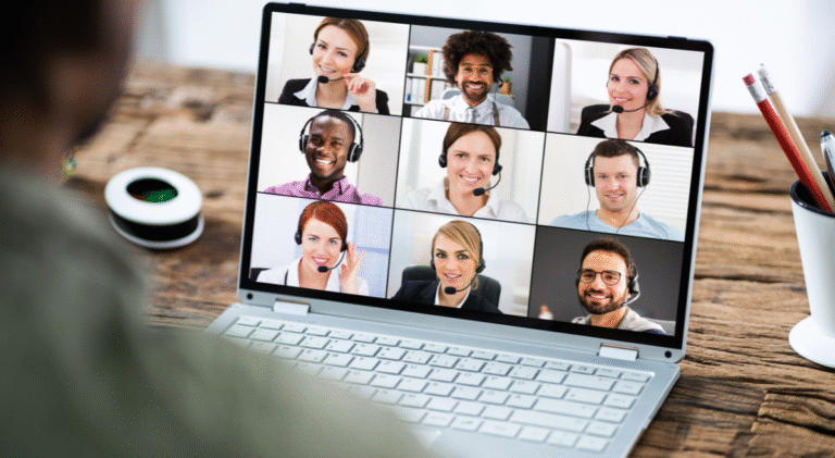 Coach hosting a virtual session with clients on a laptop, symbolizing a successful online coaching business