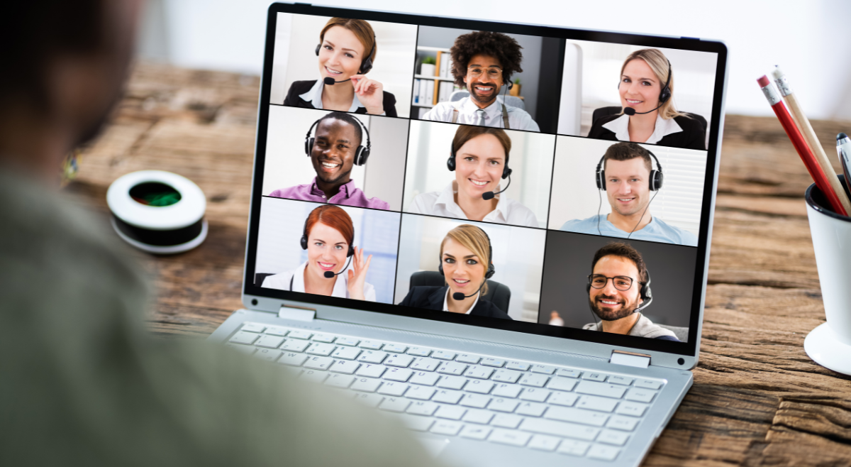 Coach hosting a virtual session with clients on a laptop, symbolizing a successful online coaching business