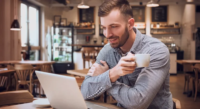 A person working on a laptop with affiliate dashboards and sales analytics, representing affiliate marketing explained.
